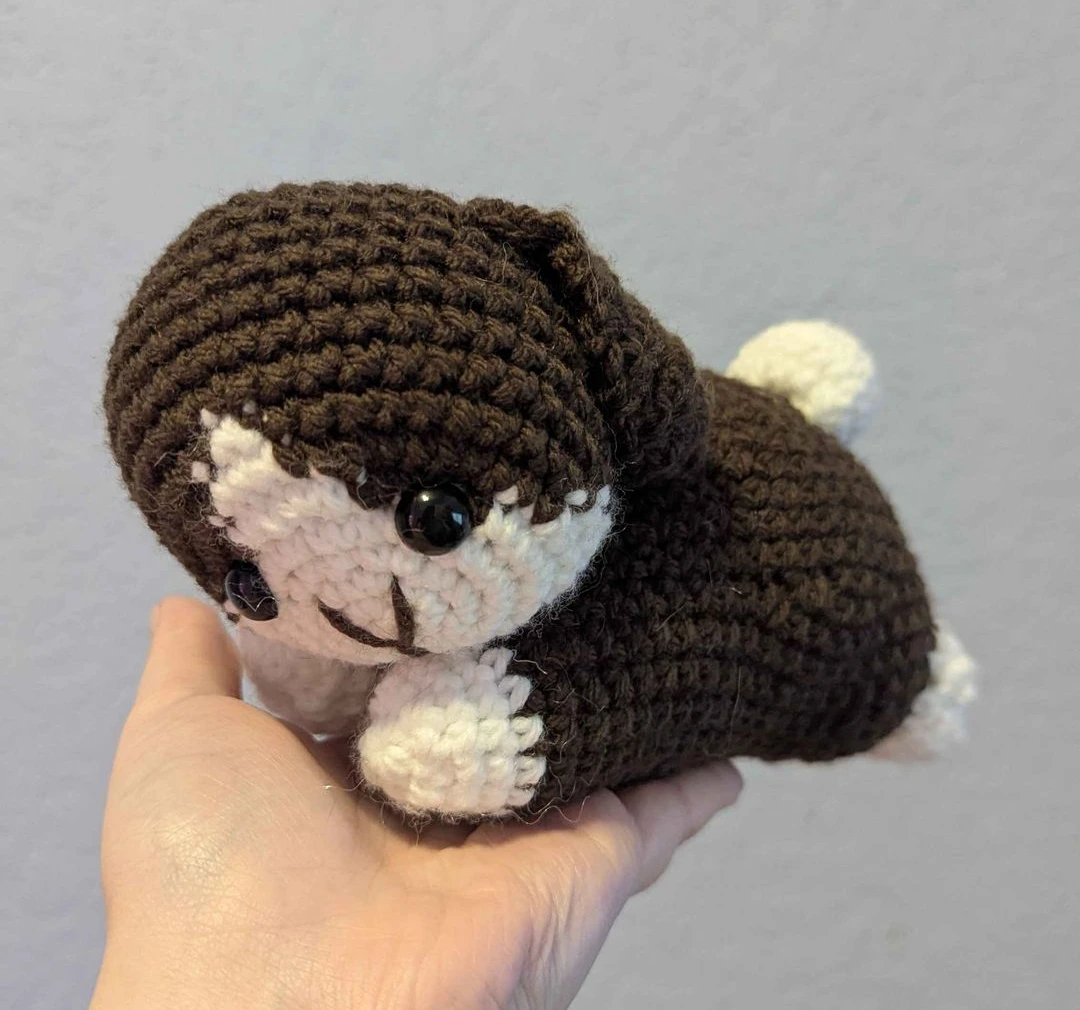 Crocheted brown bunny with a white face, paws and tail